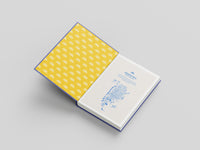 Open notebook with yellow interior and blue design on a gray background